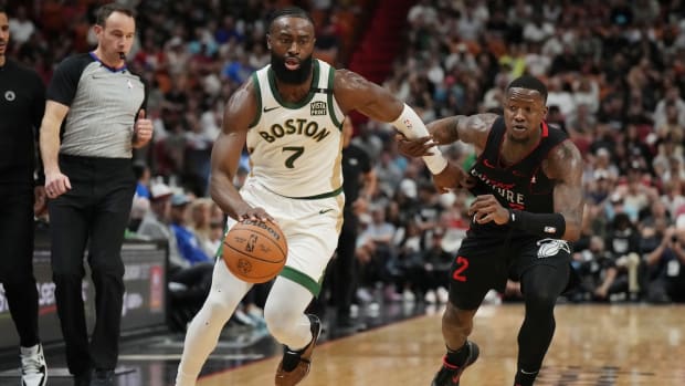 Boston Celtics guard Jaylen Brown drives past Miami Heat guard Terry Rozier during the first half at Kaseya Center in Miami on Feb. 11, 2024.